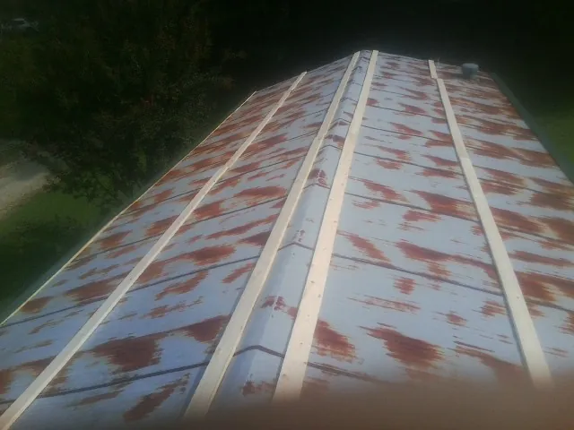 Rusted metal roof panels with new wood purlins before replacement — Storm Damage Roof Repair in San Leandro by Roofing Brothers