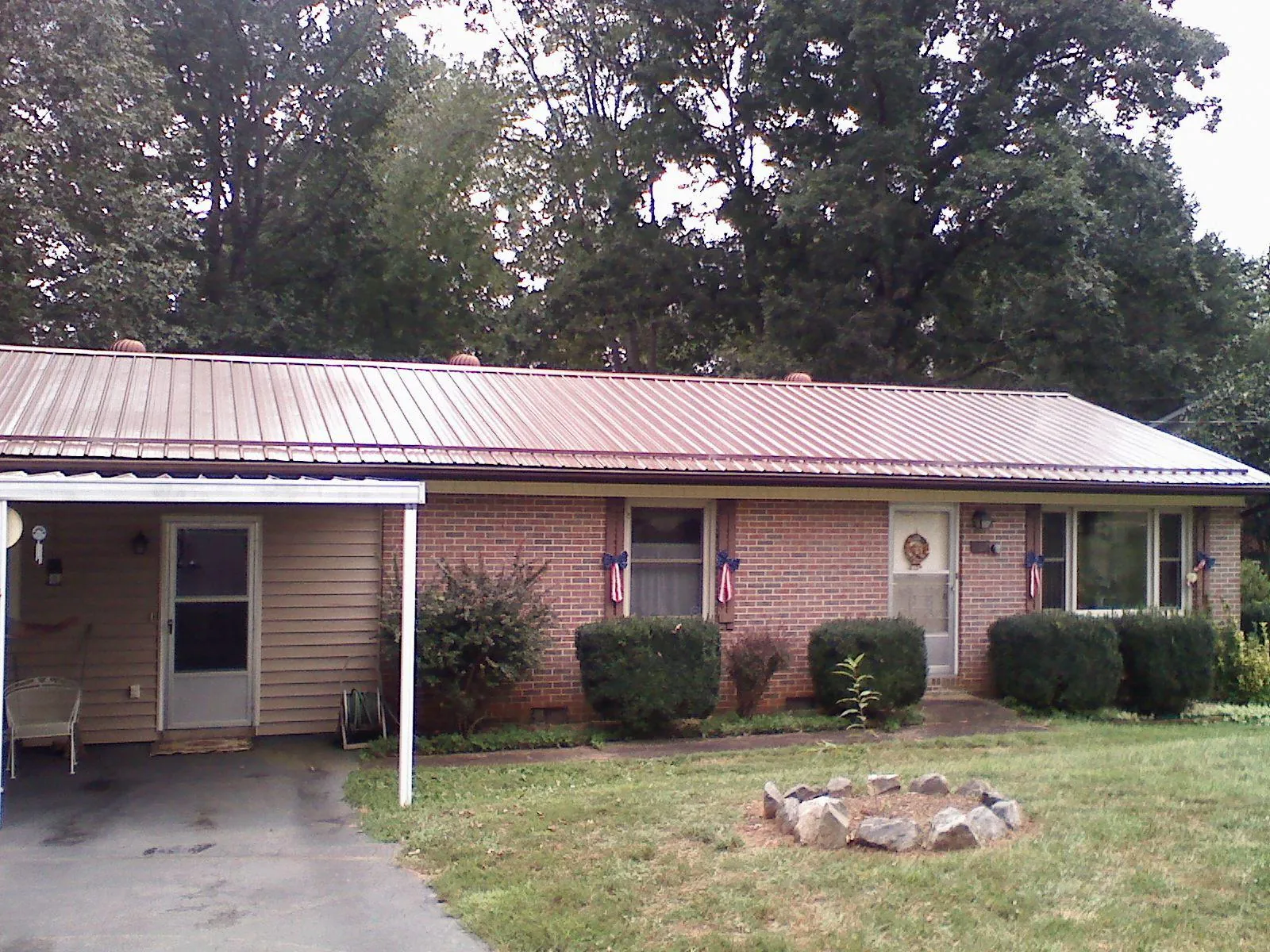 Bronze metal roof and carport on a brick ranch home — Roof Repair work by our crew in San Leandro